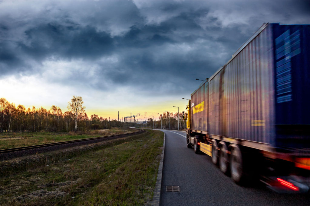 Truck on the road in stormy day.